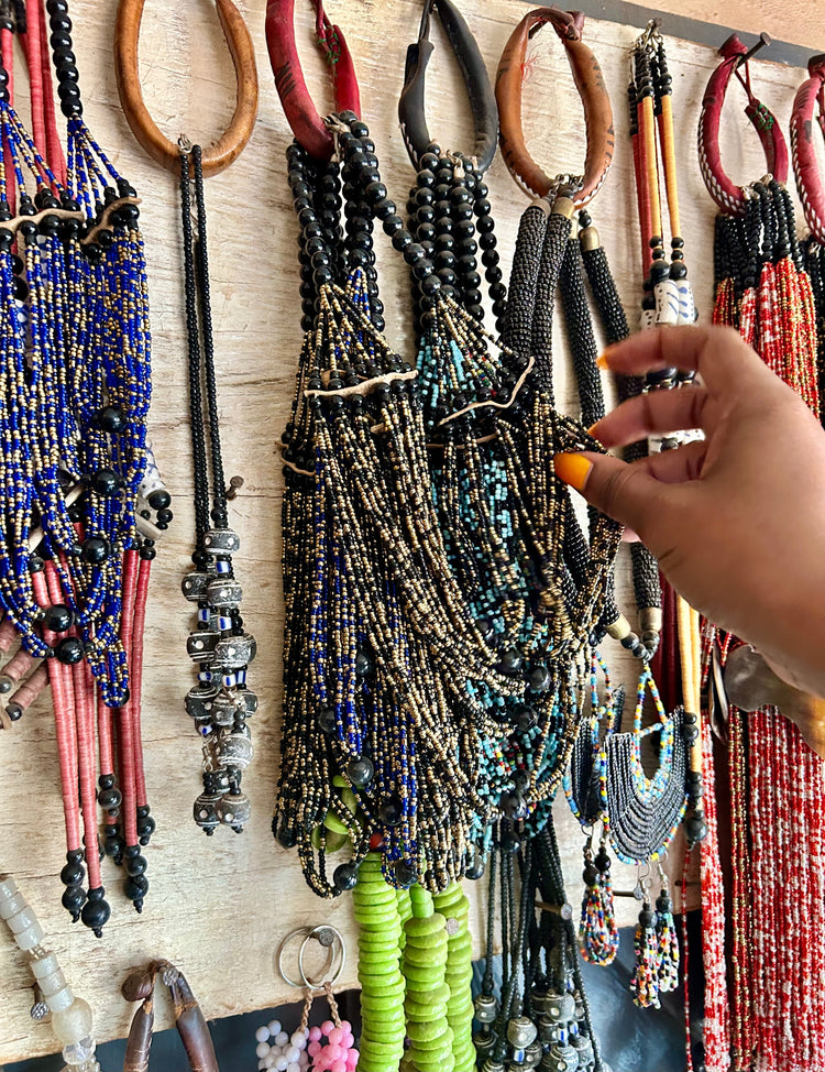 Handcrafted beaded necklaces, being selected in a market