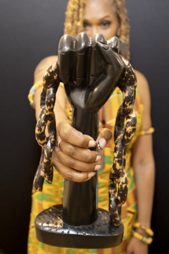 Uniquely sculpted Black Power statue made from Ebony wood made in Kumasi, Ghana.